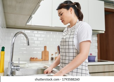 Photo of house wife displeased working alone tired carry heavy dishes wear dotted apron bright kitchen