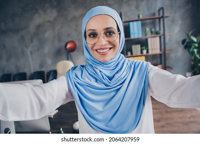 Photo of hr millennial arabic lady do selfie wear spectacles hijab shirt indoors workplace - Powered by Shutterstock