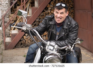 Photo Of Humor. The Biker Makes A Funny Facial Expression.