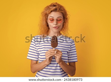 photo of hungry girl with icelolly ice cream at summer. girl with icelolly ice cream