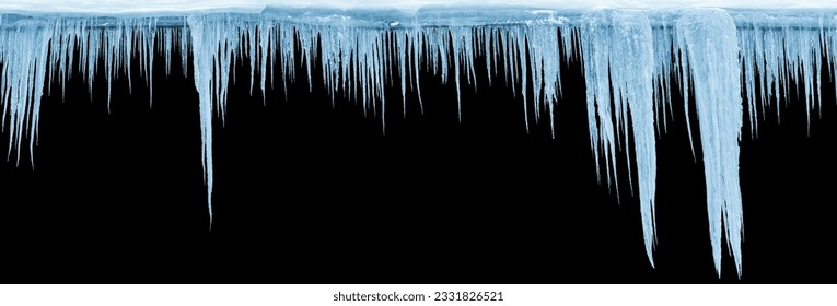 Photo icicles group on an black background, isolated object. Panoramic photo.