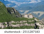 Photo of iconic holed stone in the middle of São Joaquim National Park, in Urubici, state of Santa Catarina, Brazil.