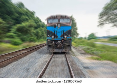 Photo illustration of an oncoming locomotive with no logos and a ficticious color scheme, in a scary zoom blur. - Shutterstock ID 1238559568