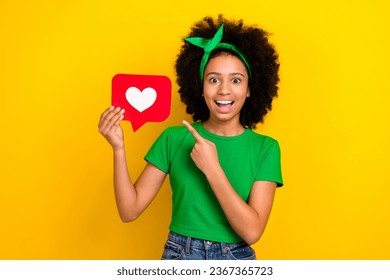 Photo of impressed beautiful teenager schoolgirl open mouth direct finger arm hold like notification icon isolated on yellow color background - Shutterstock ID 2367365723