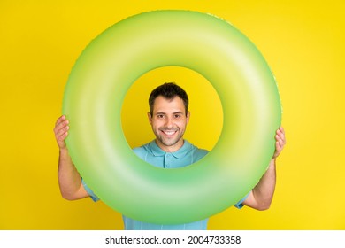 Photo Of Impressed Brunet Man Hold Circle Wear Blue T-shirt Isolated On Yellow Color Background