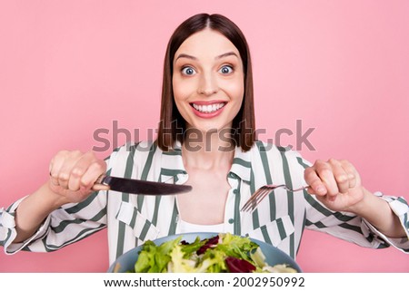 Photo of impressed brunette millennial lady want eat salad wear white shirt isolated on pink color background