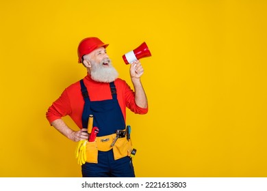 Photo of impressed cool old guy dressed uniform overall red hardhat making announcement empty space isolated yellow color background - Powered by Shutterstock