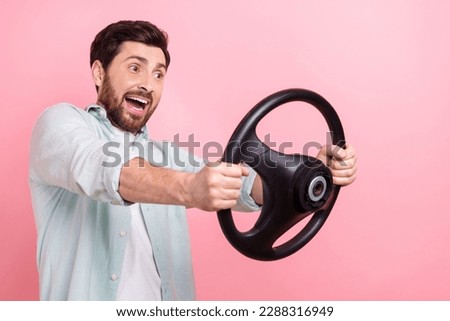 Photo of impressed crazy guy hold volkswagen steering wheel fast speed high sensitivity bad road surface isolated on pink color background