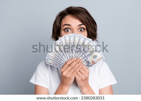 Photo of impressed excited lady wear white t-shirt money fan close lips isolated grey color background