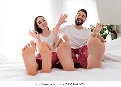 Photo of impressed funky boyfriend girlfriend sleepwear waving arms hi indoors home bedroom - Powered by Shutterstock