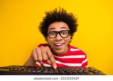 Photo of impressed funky man wear striped t-shirt spectacles chatting modern device isolated yellow color background - Shutterstock ID 2313555429