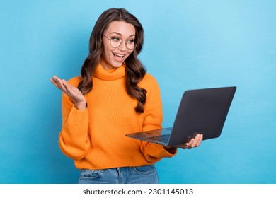 Photo of impressed funny lady dressed orange pullover eyewear chatting apple samsung gadget isolated blue color background - Shutterstock ID 2301145013