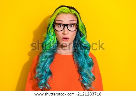 Photo of impressed funny young vibrant woman wear orange t-shirt spectacles big eyes isolated yellow color background