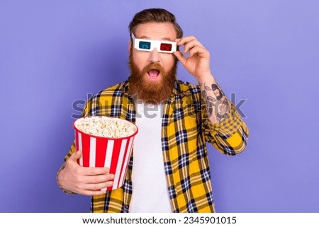 Photo of impressed man wear checkered trendy clothes watching horror science fiction movie 3d goggles isolated on purple color background