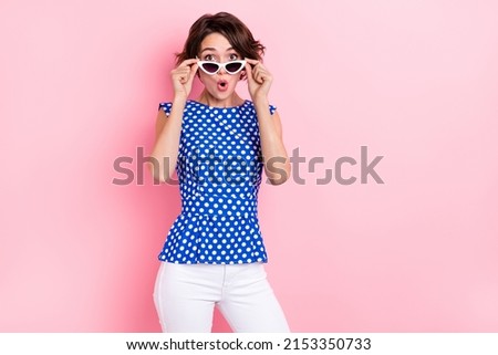 Photo of impressed millennial brunette lady open mouth wear glasses blouse jeans isolated on pink color background