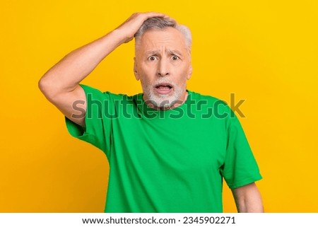 Photo of impressed shocked guy dressed green t-shirt arm head open mouth isolated yellow color background