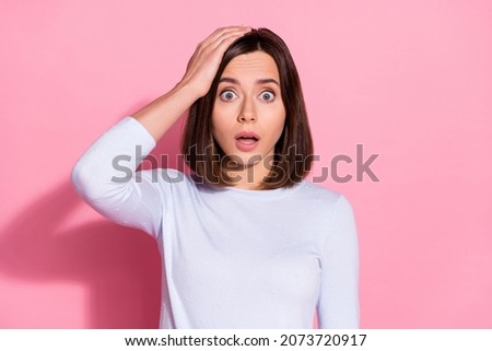Photo of impressed shocked young lady dressed white jumper arm head hearing bad news isolated pink color background