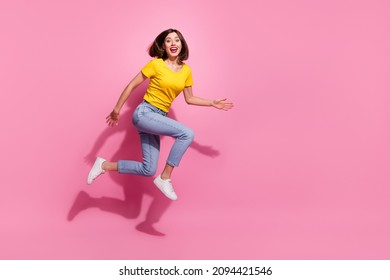 Photo Of Impressed Sweet Young Woman Wear Yellow Outfit Jumping High Running Fast Empty Space Smiling Isolated Pink Color Background