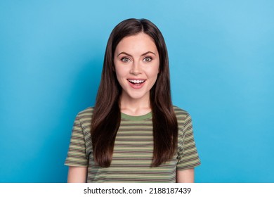 Photo of impressed young brunette lady wear green t-shirt isolated on blue color background - Shutterstock ID 2188187439