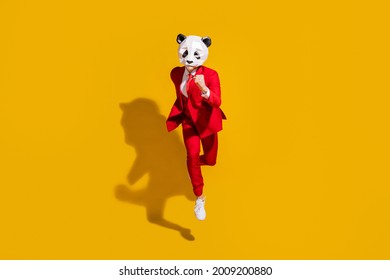 Photo Of Incognito Panda Guy Jump Run Fast Wear Mask Red Tuxedo Footwear Isolated On Yellow Color Background