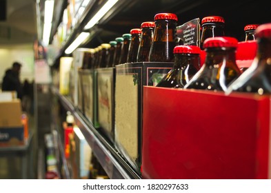 Photo From Inside A Store Of Drinks Sitting A Shelf. Going Off Into A Blurred Background.