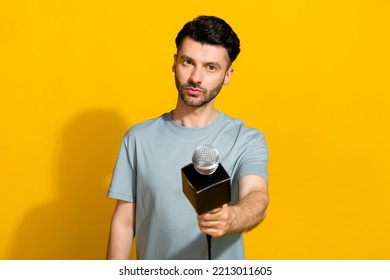 Photo Of Intelligent Man Wear Stylish Clothes Hand Hold Mic Ask You Question Share True News Tv Channel Isolated On Yellow Color Background