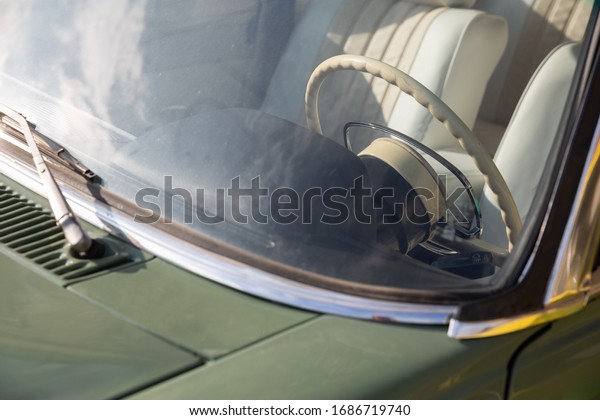 Photo of interior of vintage car with\
light saloon and details. Old car classic\
concept.