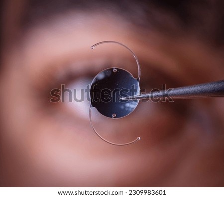 photo of intra ocular lens IOL for treating cataract infront of surgeon eye Stock foto © 