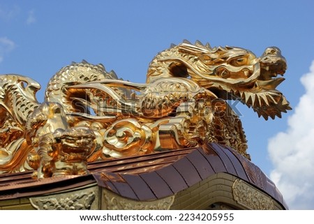 Photo of Japanese golden colored dragon statue.