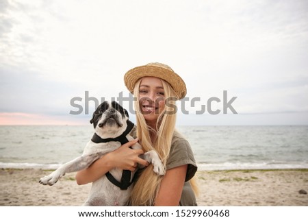 Similar – Junge Frau mit blondem Labrador am Ostseestrand