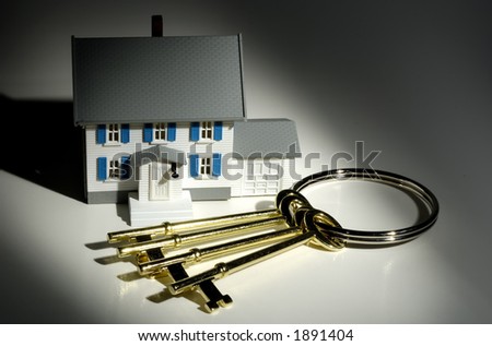 Photo of Keys and a Miniature House - Real Estate Concept