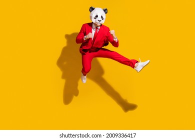 Photo Of Kung-fu Panda Guy Jump Hold Fists Kick Leg Empty Space Wear Mask Red Tux Shoes Isolated On Yellow Color Background