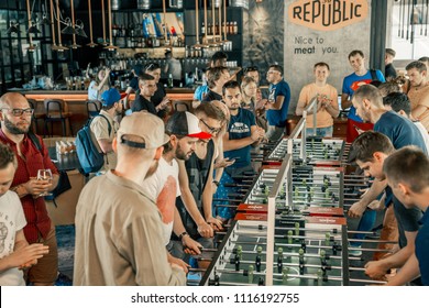 Photo KYIV, UKRAINE, bar league of Grants KickerKicker 10 June 2018. Active men and women have fun during table soccer game.