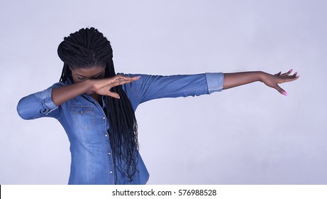 Photo of a lady dabbing , wearing a denim shirt in a white background.