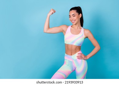 Photo Of Lady Doing Body Building Demonstrate Muscles Wear Rainbow Print Top Leggings Pants Isolated Blue Color Background