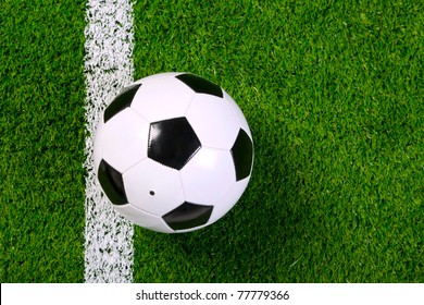 Photo Of A Leather Football Or Soccer Ball On A Grass Next To The White Line, Shot From Above.