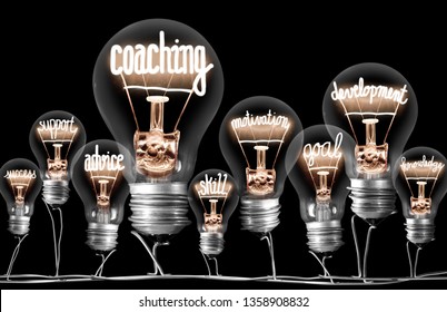 Photo Of Light Bulbs Group With Shining Fibers In A Shape Of Coaching Concept Related Words Isolated On Black Background