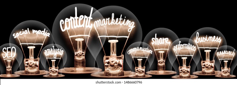 Photo of light bulbs with shining fibers in a shape of Content Marketing, SEO, Share and Business concept related words isolated on black background