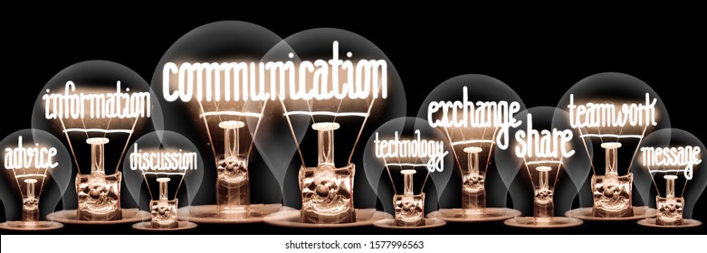 Photo of light bulbs with shining fibers in a shape of Communication, Exchange, Teamwork and Information concept related words isolated on black background