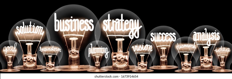 Photo of light bulbs with shining fibers in a shape of Business Strategy, Solution, Success, Analysis and Planning concept related words isolated on black background