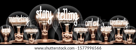 Photo of light bulbs with shining fibers in shapes of Story Telling, Marketing, Content and Creativity concept related words isolated on black background