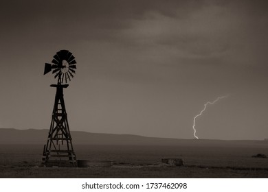 Photo Of Lightning Striking The Wyoming Plains Behind A Windmill