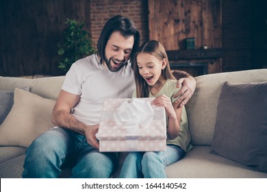 Photo Of Little Adorable Funny Lady And Her Handsome Young Daddy Sit Cozy Sofa Giving Receiving Large Giftbox Birthday Present Gift Celebrate Domestic Atmosphere Indoors