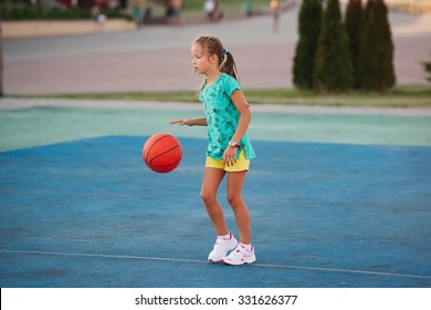 Photo Of Little Cute Girl Playing Basketball Outdoors