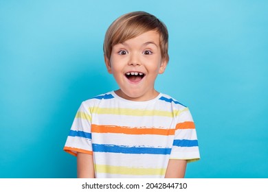 Photo of little funny blond boy wear white t-shirt isolated on blue color background - Shutterstock ID 2042844710