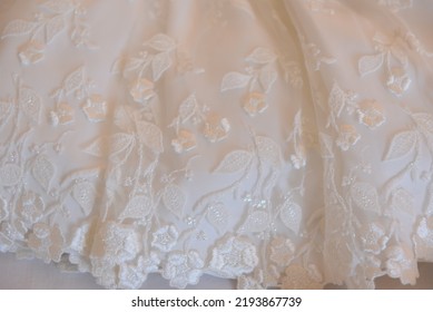 Photo Of A Little Girl's Dress During A Ceremony On A White Background.
Photo Taken In The Bedroom
White Lace Dress