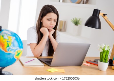 Photo Of Little Pretty Upset Pupil Small School Lady Browsing Laptop Notebook Read Teacher Marks List Bad Semester Results Sit Desk Distance Quarantine Study Living Room Classroom Indoors