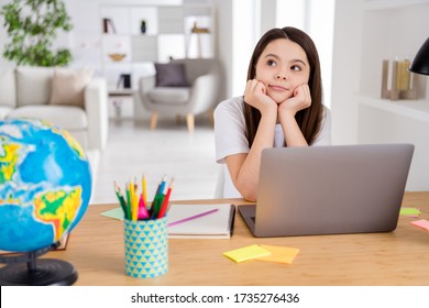 Photo Of Little School Girl Wait Notebook Online Lesson Conference Minded Think Over Summer Holidays Vacation Sitting Table Look Dreamy Up Distance Quarantine Study Comfort Room Indoors