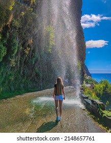 Photo Of A Long Hair Blond Beautiful Girl Going Under The Waterfall Of Angels Waterfall (Cascata Dos Anjos) In Madeira Island. 