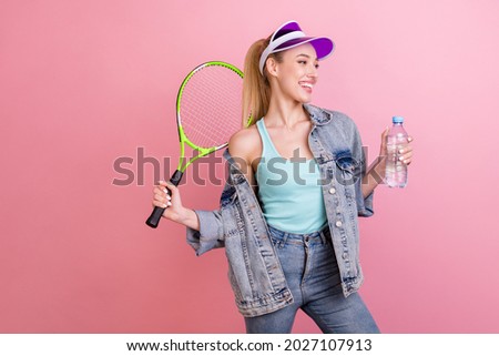 Photo of lovely blond young lady play tennis look empty space wear blue top jacket visor isolated on pink color background